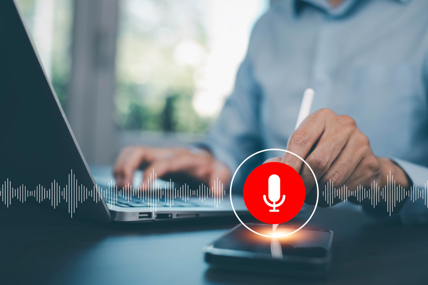 A person using a laptop and smartphone with a voice search microphone icon, symbolizing website optimization for voice search in 2025